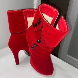 Red velvet heeled boots with black buttons on the side, size 5.5